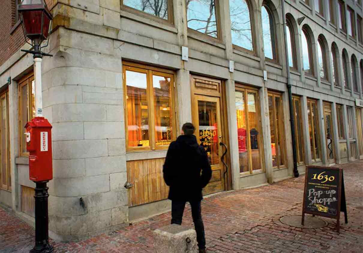 Man walks up to 1630 exterior at Faneuil Hall