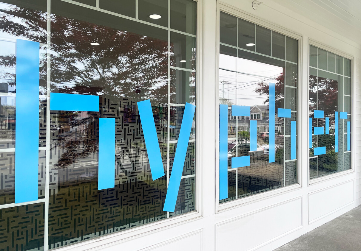 The front windows show the large hyphen vinyl graphics