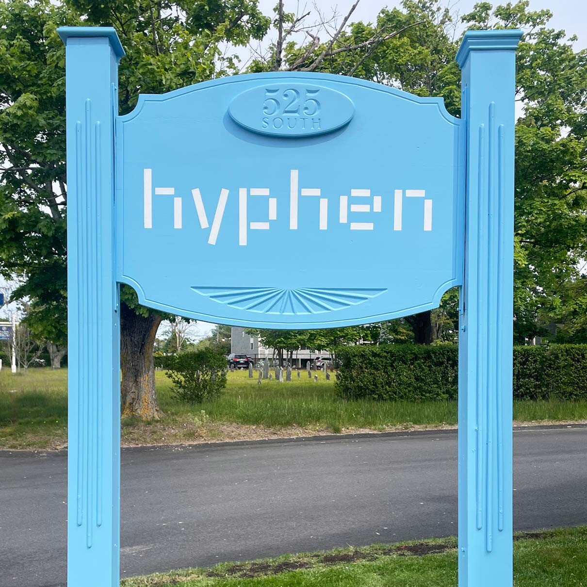 The exterior hyphen sign stands freshly painted