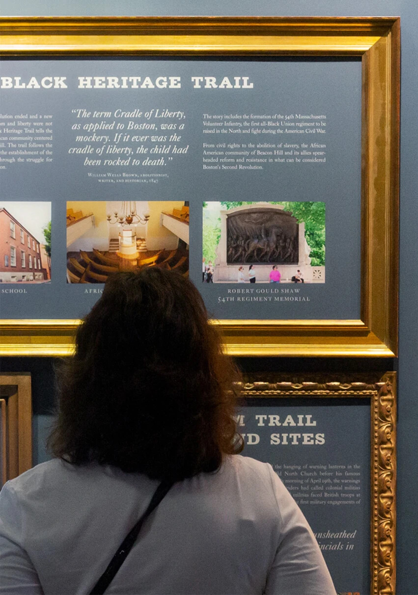 visitor reads about the Black Heritage Trail in Boston