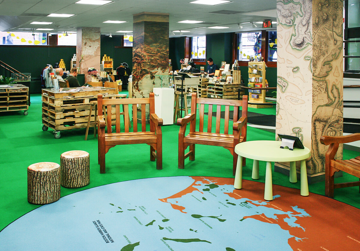 National Parks of Boston temporary visitor center interior with camp furniture and turf and map flooring